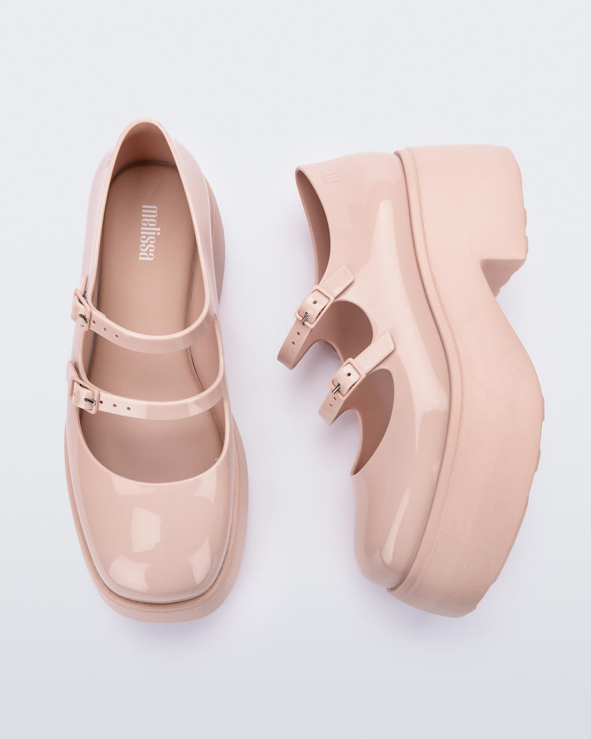 A top and side view of a pair of pink Melissa Farah platform shoes with two straps fastened by pink buckles.
