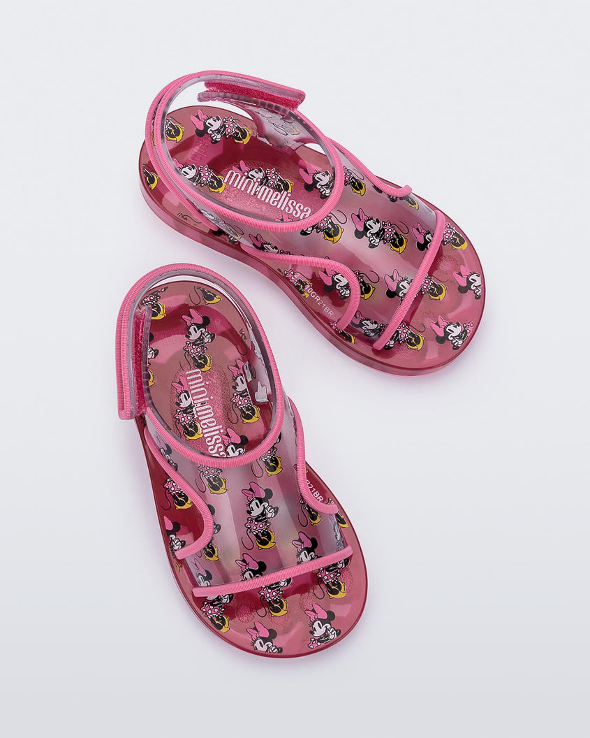 Top view of a pair of pink Mini Melissa Acqua sandals with Mickey Mouse print