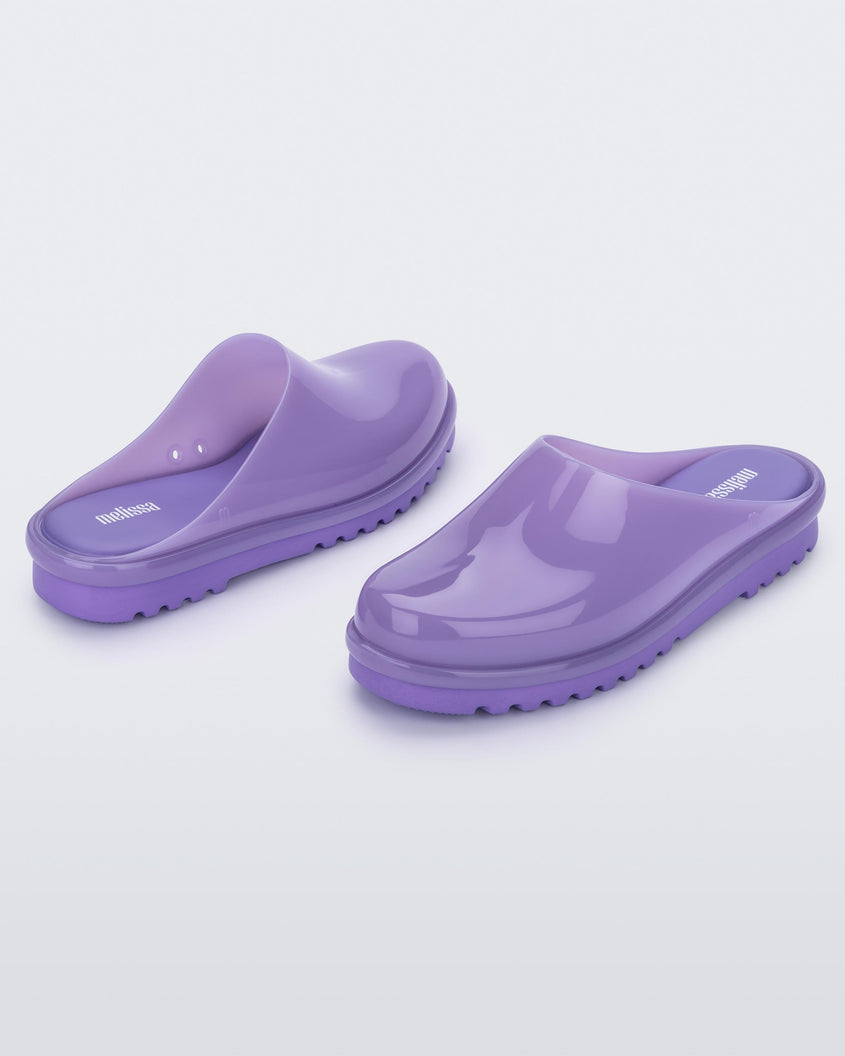 An angled front and back view of a pair of lilac Melissa Smart Clogs.