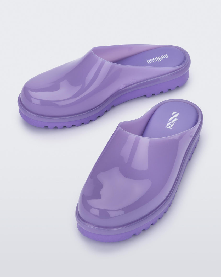 An angled front and top view of a pair of lilac Melissa Smart Clogs.