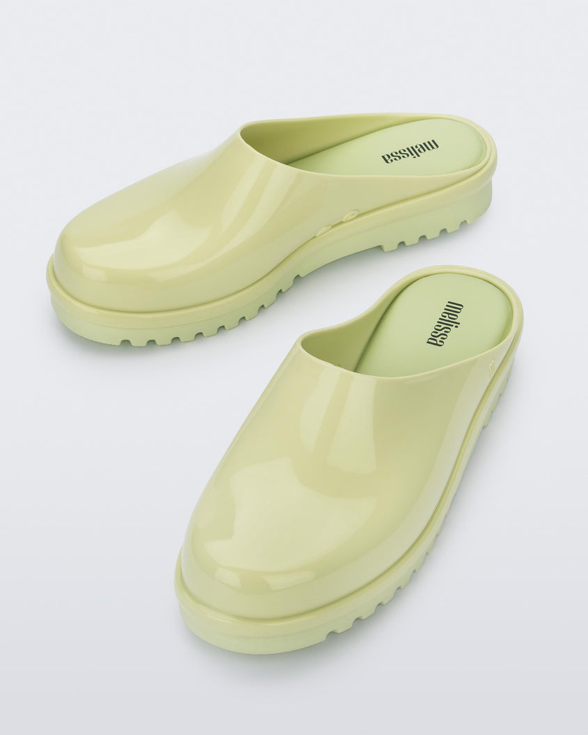 An angled top view of a pair of green Melissa Smart Clogs.