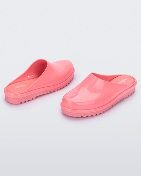 An angled front and back view of a pair of pink Melissa Smart Clogs.