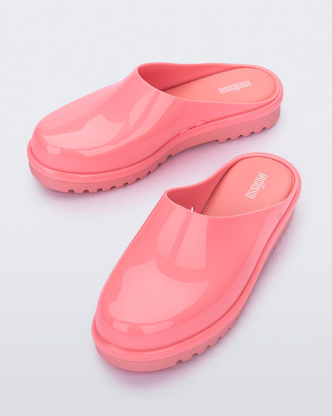 A top and front view of a pair of pink Melissa Smart Clogs.