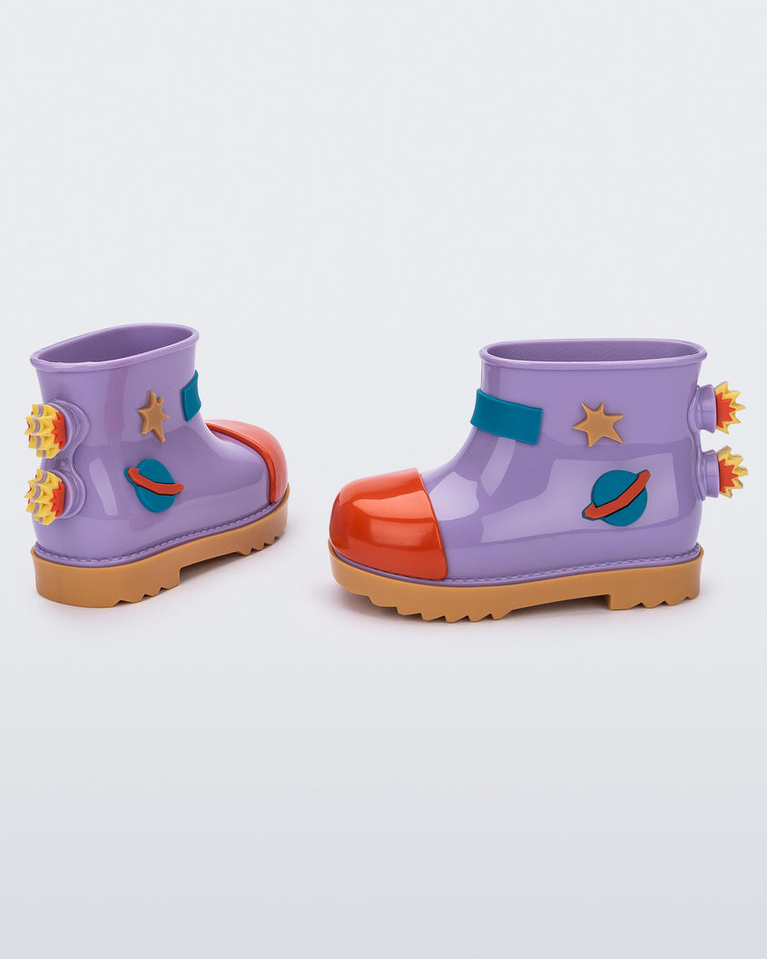 An angled side and back view of a pair of carmel/lilac/red Mini Melissa Rain Boot with a lilac base, red toe, brown sole, and a planet, star and fire detail on the side and back.
