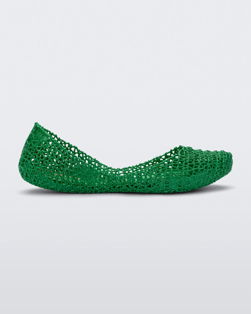 Side view of a green Melissa Campana flat with an open woven texture.