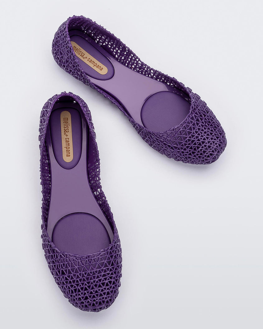 overhead view of a pair of Melissa Campana flats in purple with an open woven texture. 