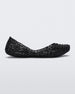 Side view of a black Melissa Campana flat with an open woven texture.