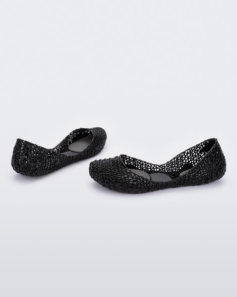Angled view of a pair of Melissa Campana flats in black with an open woven texture. 