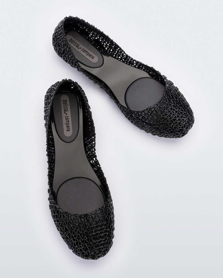 Top view of a pair of Melissa Campana flats in black with an open woven texture.