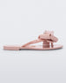 Side view of a light pink Melissa Harmonic Sweet flip flop with a light pink and glitter bow.