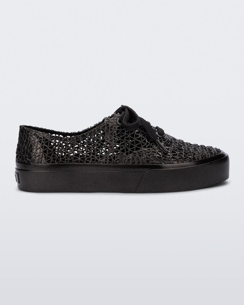 Side view of a black Melissa Campana sneaker with a woven texture base and laces.