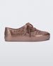 Side view of a Melissa Campana Metallic Pink sneaker with a woven texture base and laces.