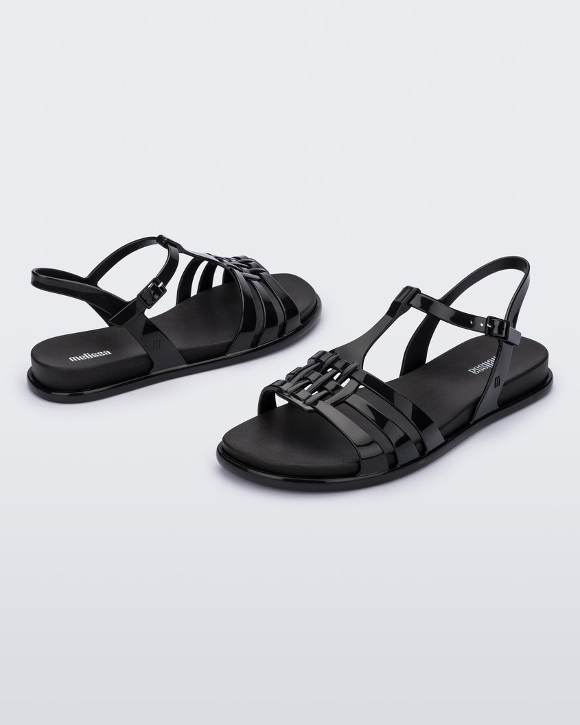Front and back view of a pair of Melissa Party sandals in black with back ankle strap and buckle closure 