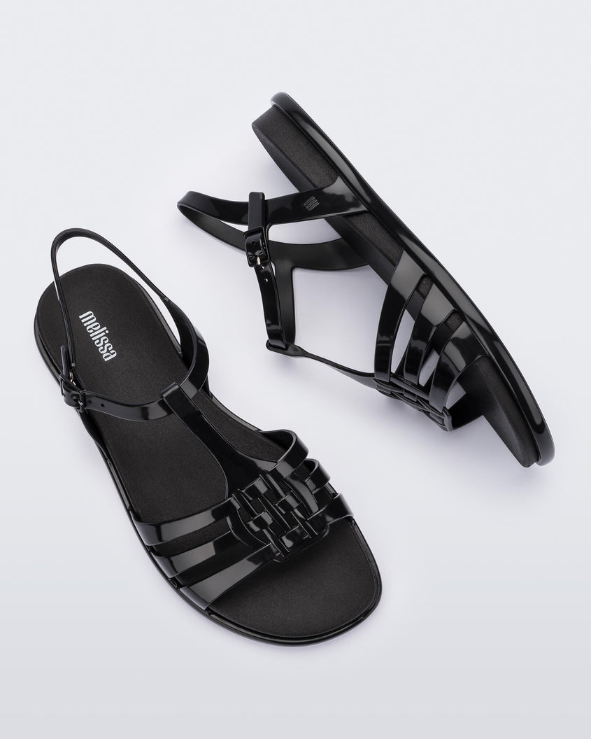 Top and side view of a pair of Melissa Party sandals in black with back ankle strap and buckle closure 