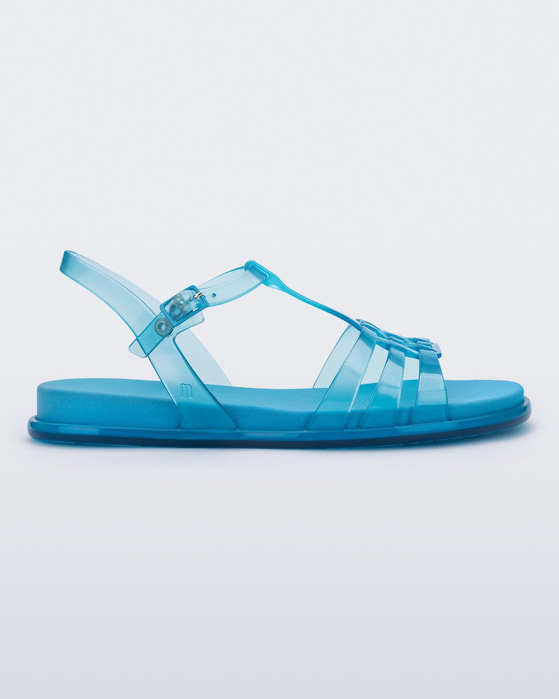 Side view of a Melissa Party sandal in transparent blue with back ankle strap and buckle closure 