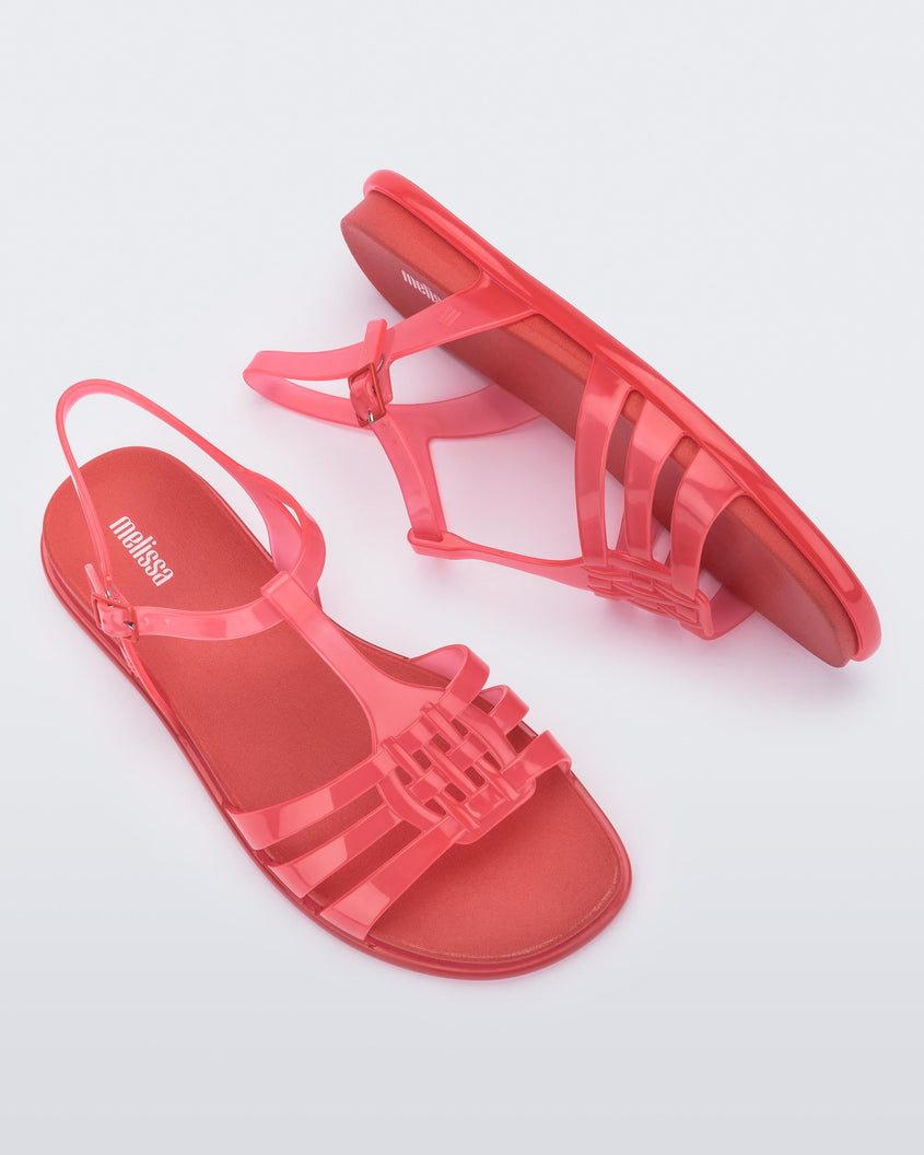 A top and side view of a pair of red Melissa Party sandals with back ankle strap and buckle closure.