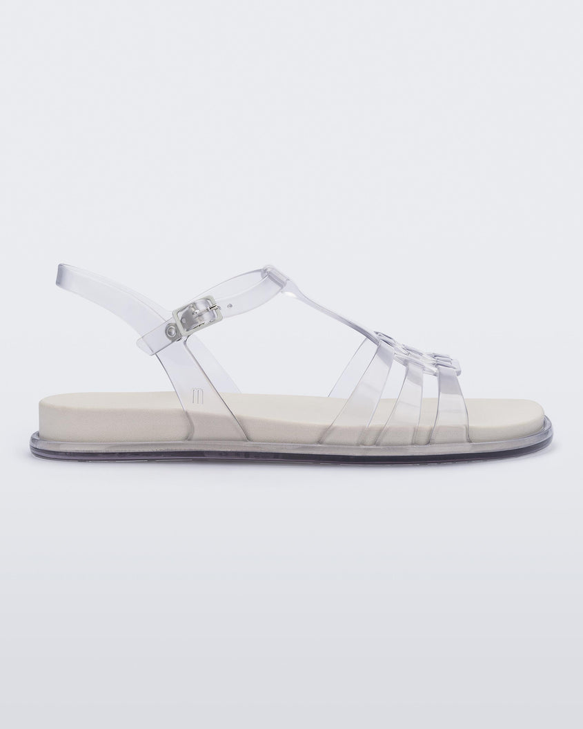Side view of a clear Melissa Party sandal with back ankle strap and buckle closure.