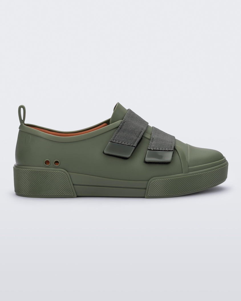 Side view of a pair of green/orange Melissa Cool sneaker with an orange insole, green base and two green velcro straps.