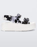 Side view of a white Melissa Brave Papete platform sandal with clear/black spotted straps.