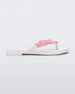Side view of a white Melissa Spring Flip Flop with pink and yellow flowers on them.