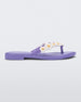 Side view of a lilac / white Melissa Spring Flip Flop with yellow and white flowers on them.
