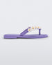 Side view of a lilac / white Mini Melissa Spring Flip Flop with white and yellow flowers.