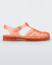 Side view of a transparent orange Melissa Possession sandal with a closed toe front weft design connected to a top strap with a buckle.