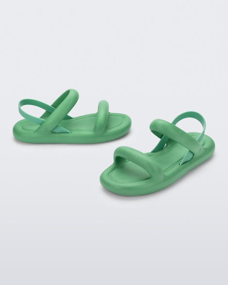 A side and angled view of a pair of green Melissa Free Bloom Sandals with puffer-like straps.