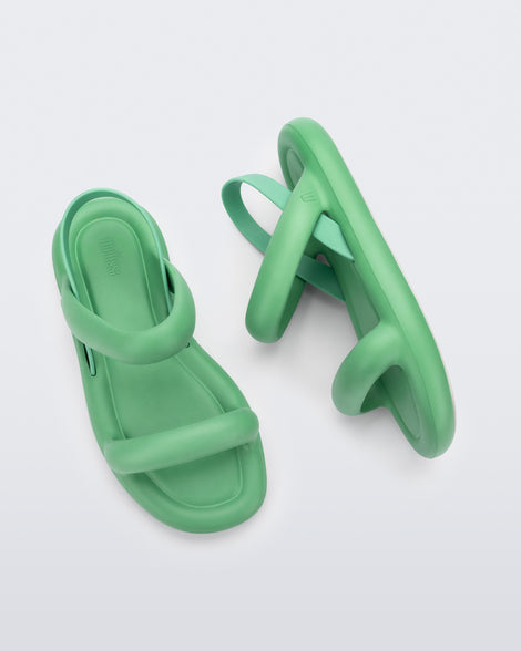 A top and side view of pair of green Melissa Free Bloom sandals with puffer-like straps.