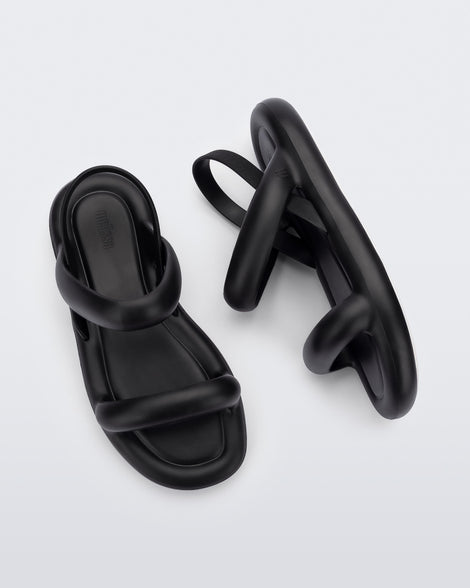 A top and side view of a pair of black Melissa Free Bloom Sandals with puffer-like straps.