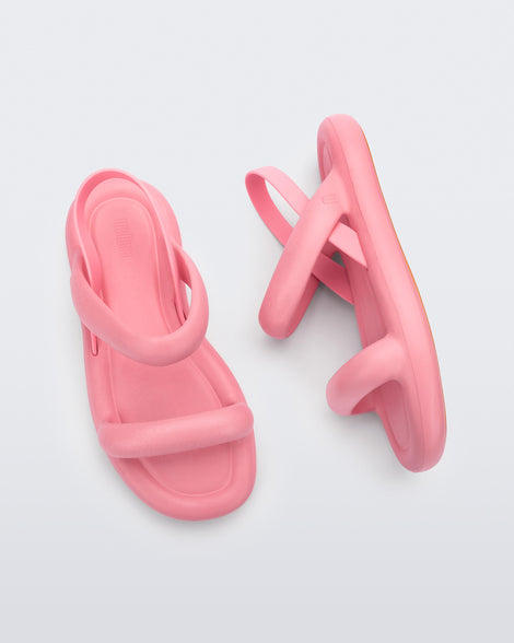 A top and side view of pair of pink Melissa Free Bloom sandals with puffer-like straps.