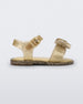 Side view of a yellow glitter Mini Melissa Mar Sandal with a heart shaped bow and buckle.