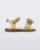 Side view of a yellow glitter Mini Melissa Mar Sandal with a heart shaped bow and buckle.