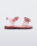 Side view of a pink glitter Mini Melissa Mar Sandal with a pink heart shaped bow and buckle.