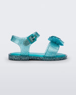 Side view of a blue glitter Mini Melissa Mar Sandal with a bow.