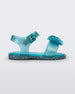 Side view of a blue glitter Mini Melissa Mar Sandal with a bow.