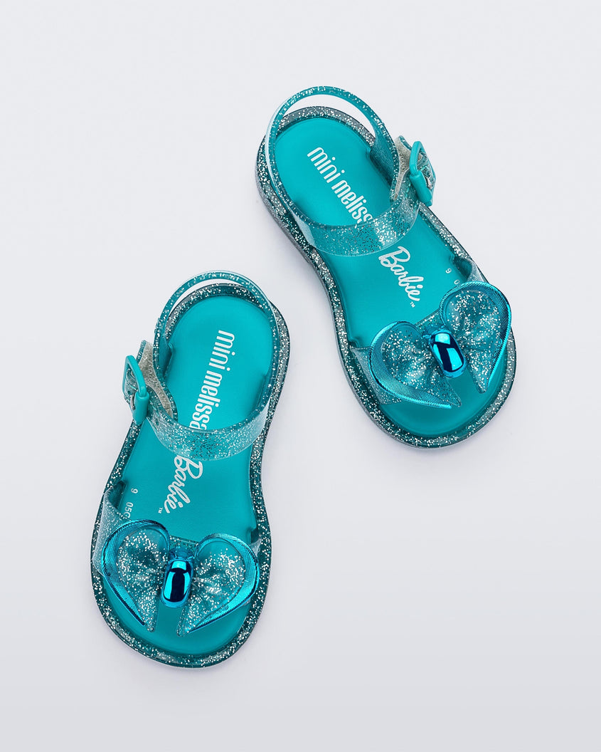 Top view of a pair of blue glitter Mini Melissa Mar Sandals with a bow.