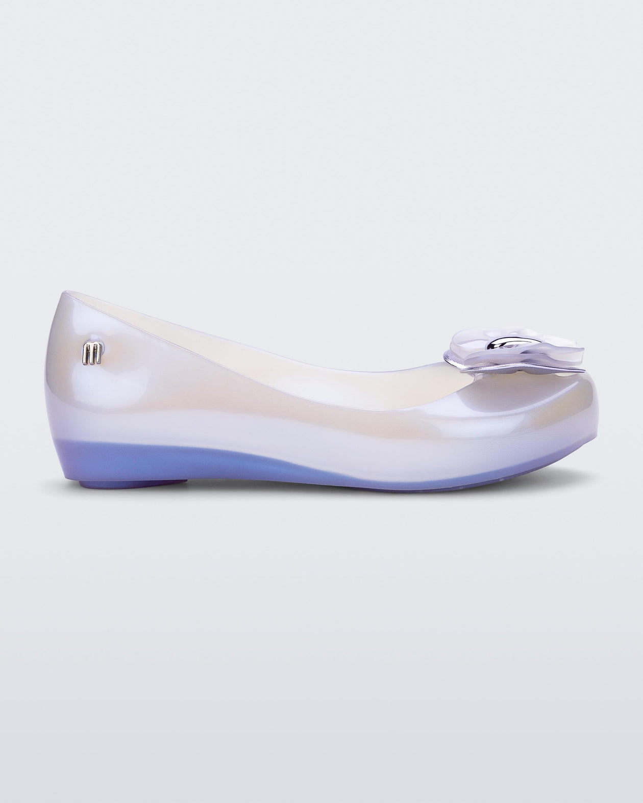 Side view of a pearly blue Mini Melissa Ultragirl flat with a pearly blue base and a heart buckle bow detail on the toe.