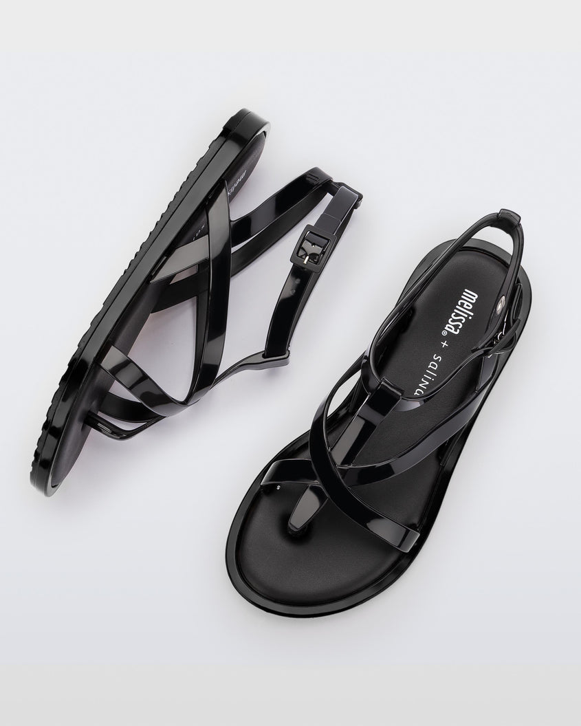 A top and side view of a pair of black Melissa Cancun sandals with several straps.