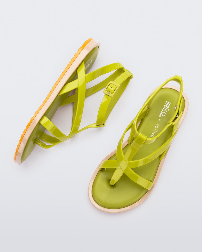 A top and side view of a pair of green Melissa Cancun sandals with several straps and a beige sole.