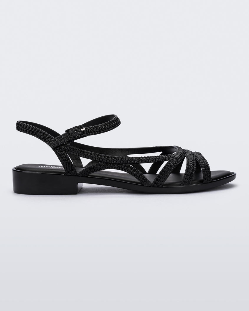 Side view of a black Melissa Femme Classy sandals with straps and a woven design.