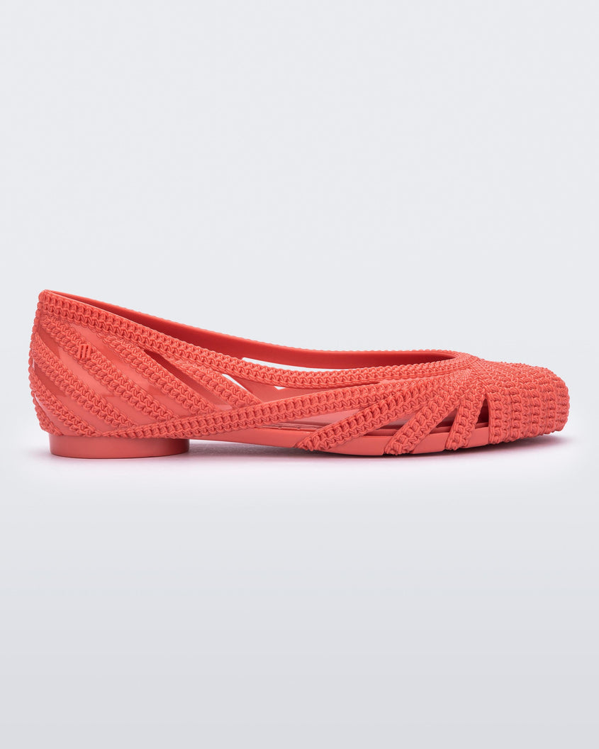 Side view of a red Melissa Femme Classy flat with a woven design.