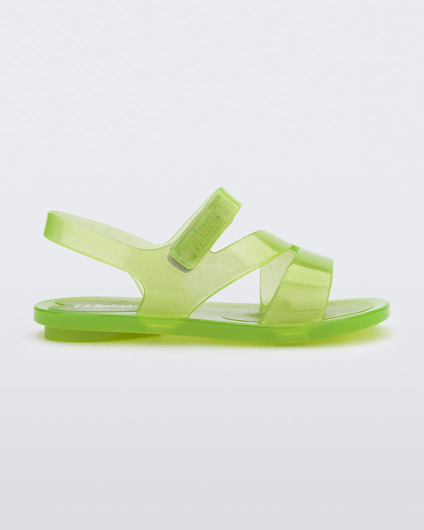 Side view of a green Mini Melissa The Real Jelly Paris slide with three straps and an ankle strap.