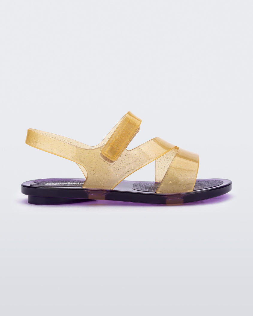 Side view of a purple/yellow Mini Melissa The Real Jelly Paris sandal with three front yellow straps, a back ankle strap and a purple sole.