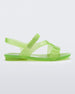 Side view of a green Mini Melissa The Real Jelly Paris sandal with a neon, transparent green base with three front straps and an ankle strap.
