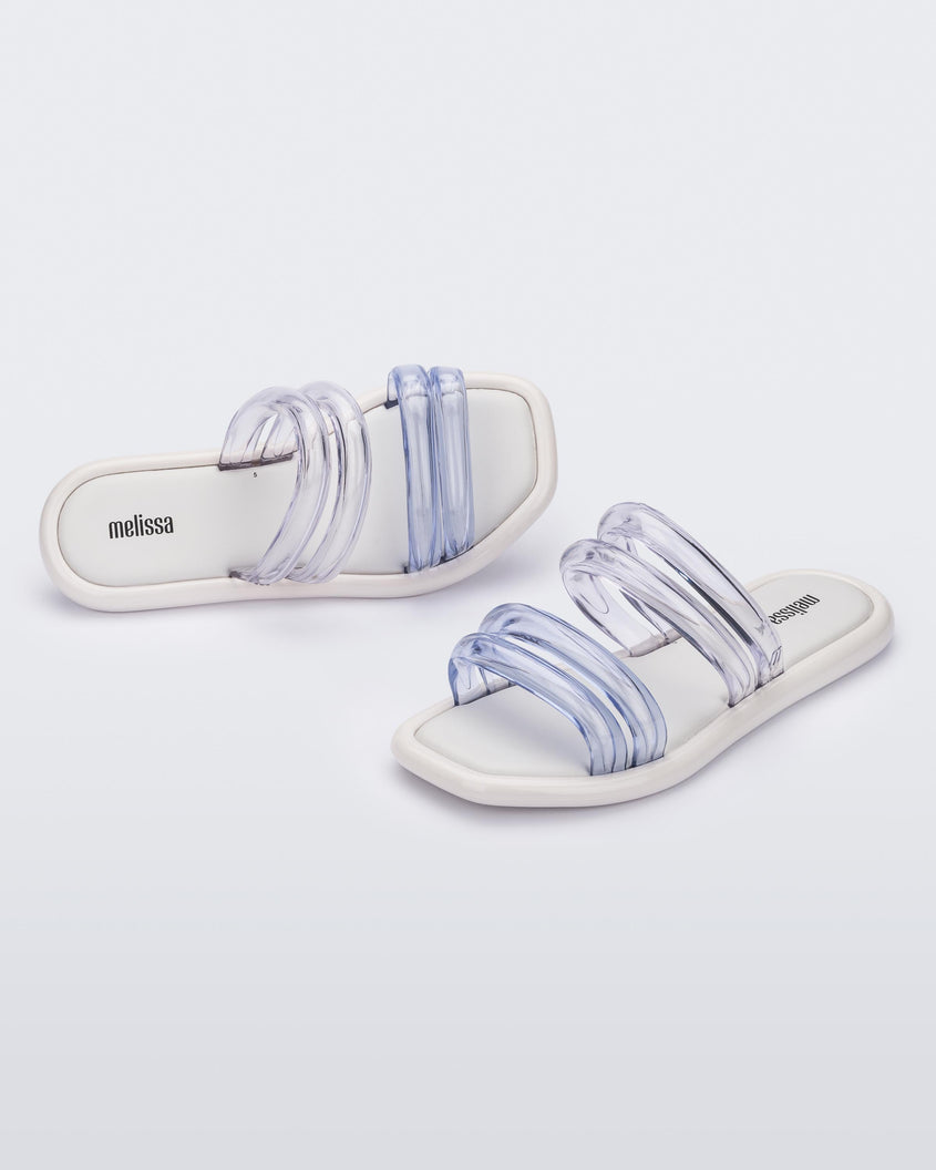 Top and angled view of a pair of white and clear Melissa Airbubble Slides