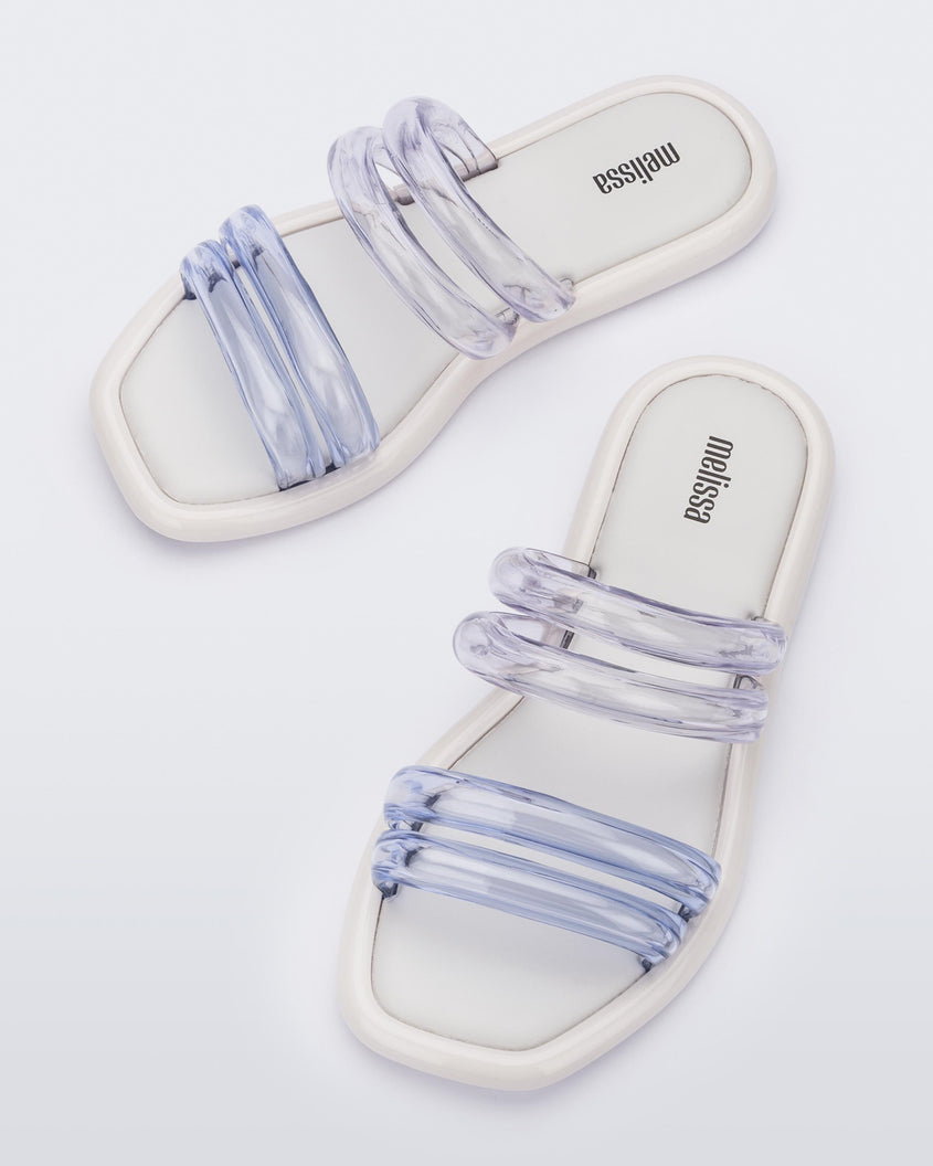 Top view of a pair of white and clear Melissa Airbubble Slides