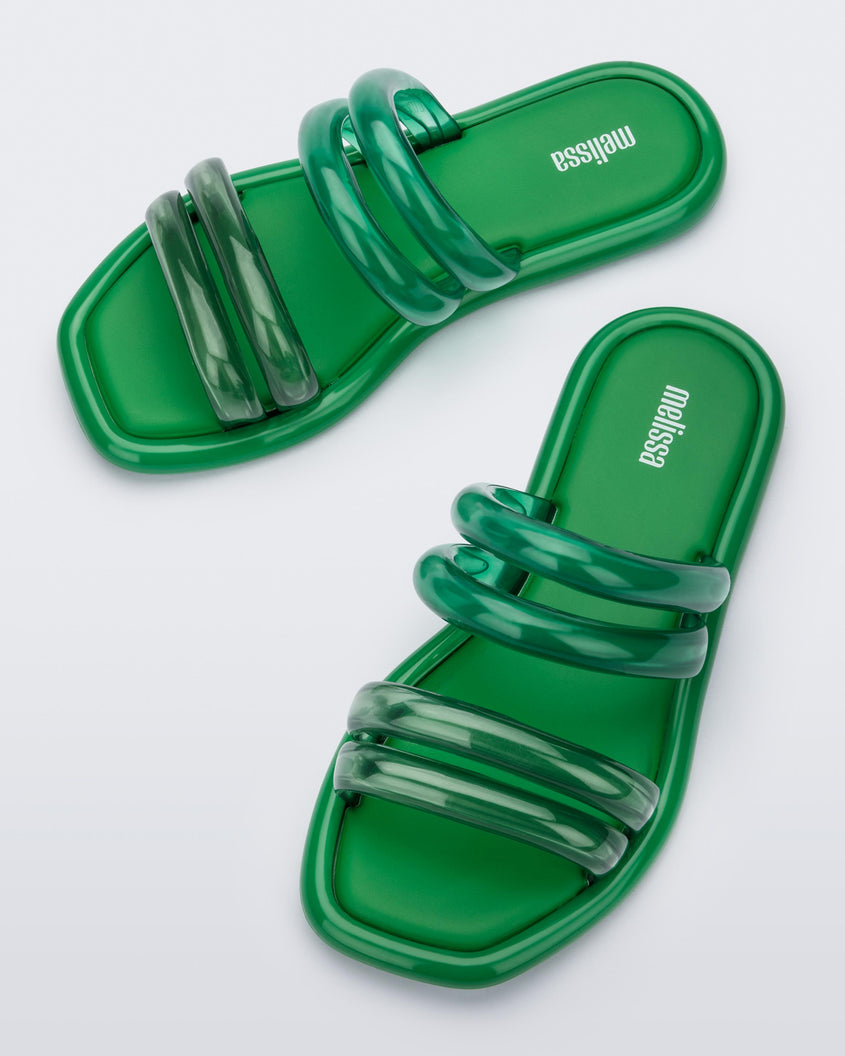 Top view of a pair of green and transparent green Melissa Airbubble Slides