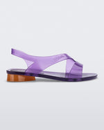Side view of a purple Melissa The Real Jelly Paris sandal with two front straps, an ankle strap and an orange heel.