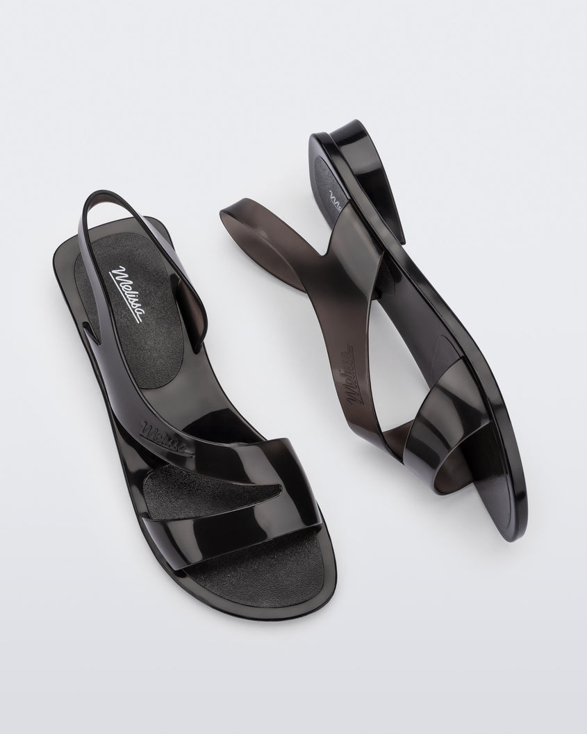 A top and side view of a pair of black Melissa The Real Jelly Paris sandals with two front straps and an ankle strap.